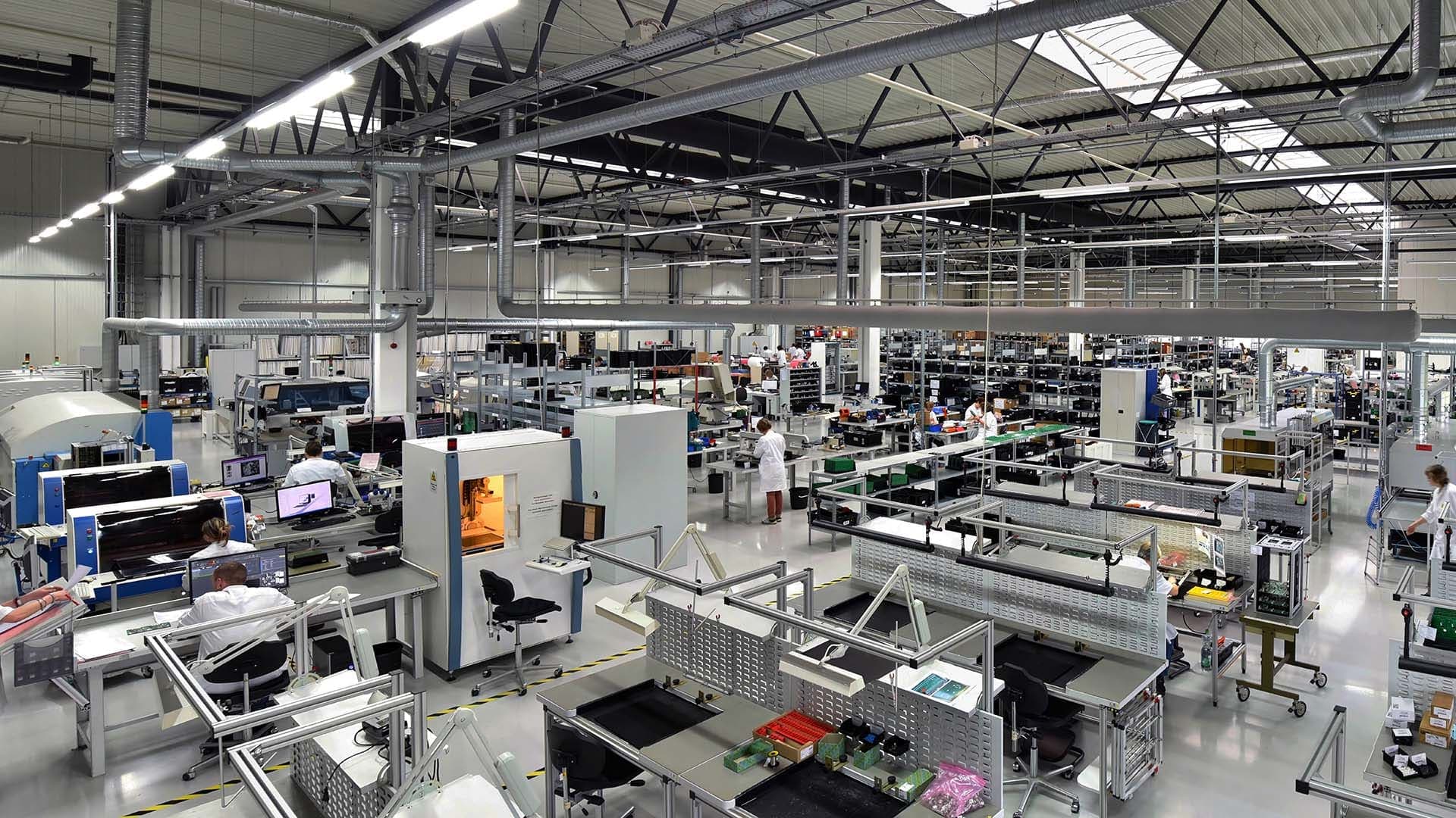 A bright, well-organised manufacturing floor with assembly workstations